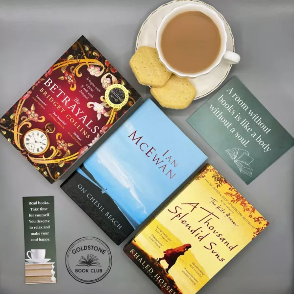 Top down view of three literary fiction paperback books and a cup of coffee with welsh shortbread on ther saucer
